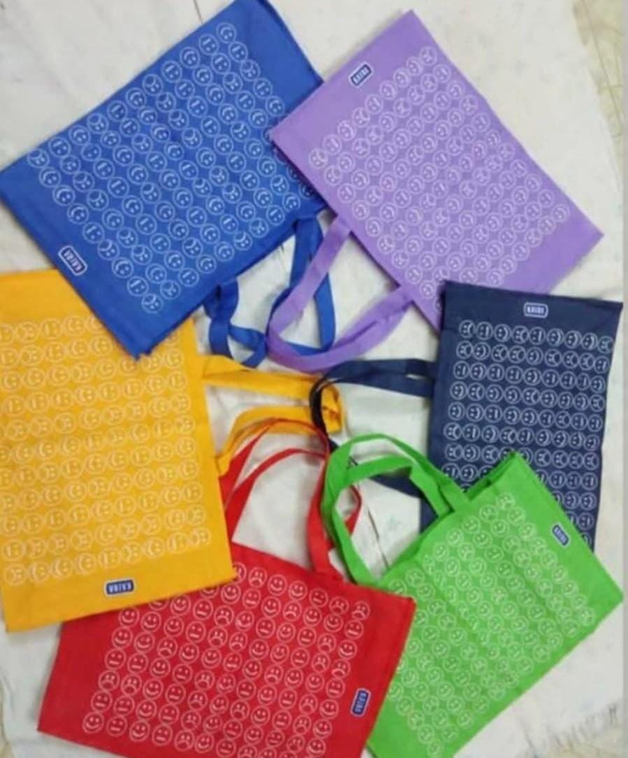 Printed tote bags in blue, purple, yellow, red and green laid out together